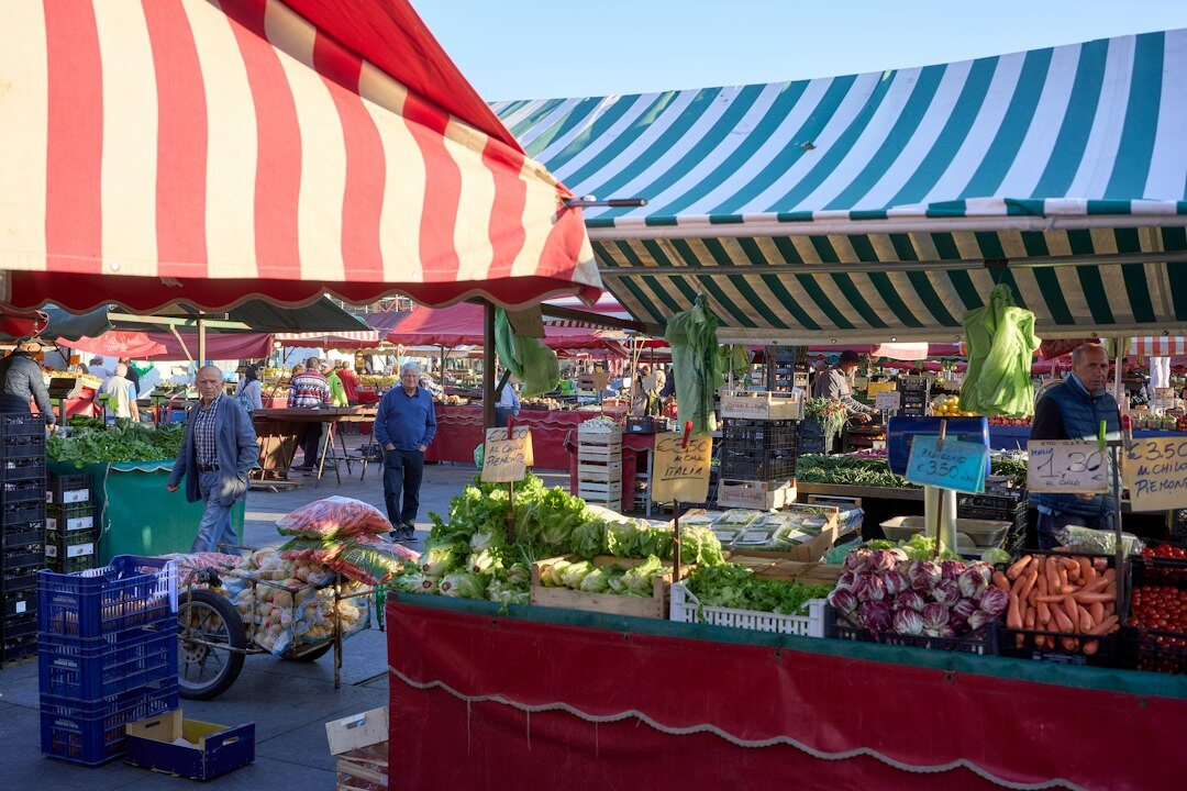 Latin American vendor arranging produce at a street market stall